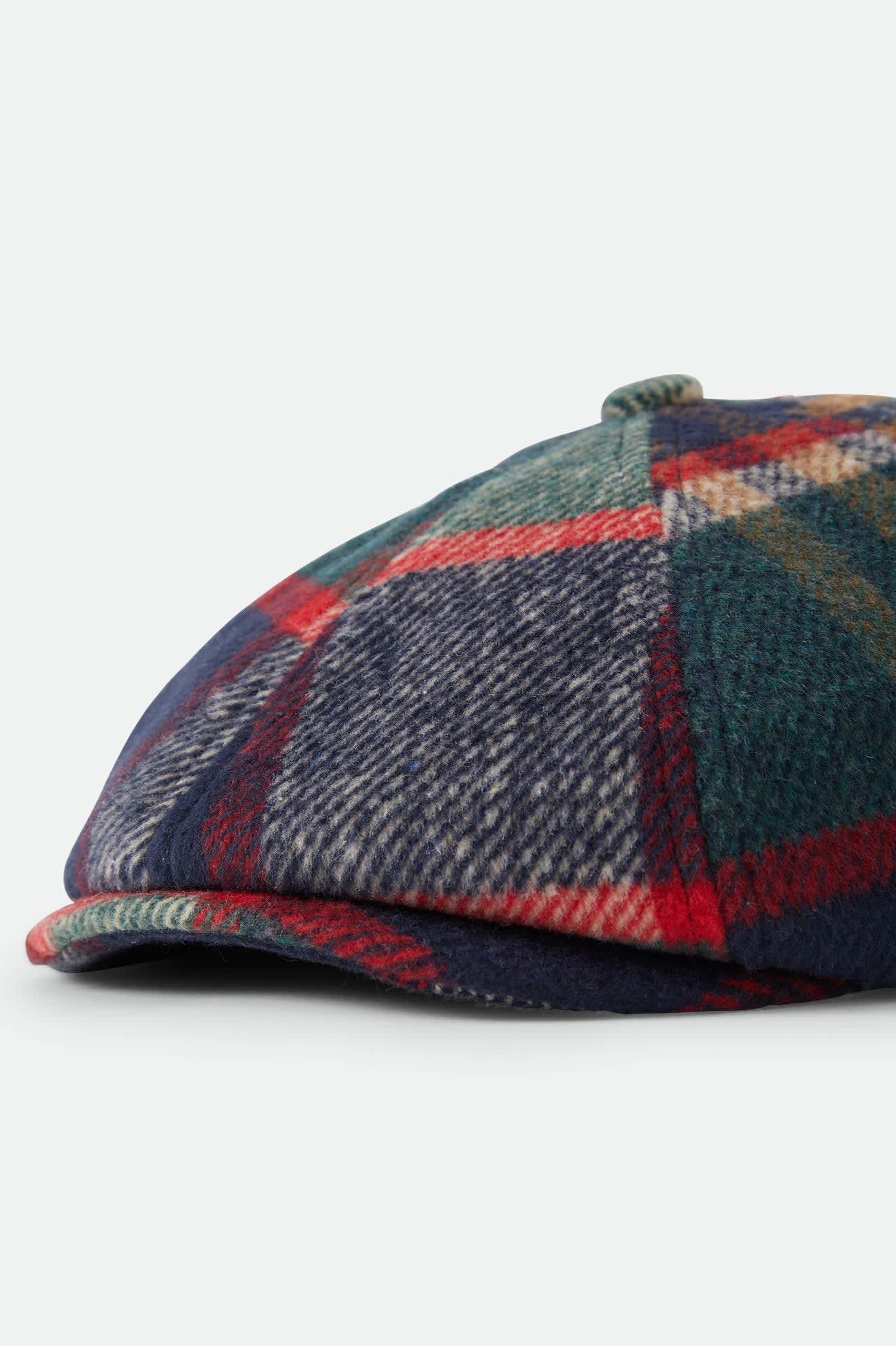 Unisex Brood Newsboy Cap in the color Navy/Green/Red/Cream - Additional Laydown image