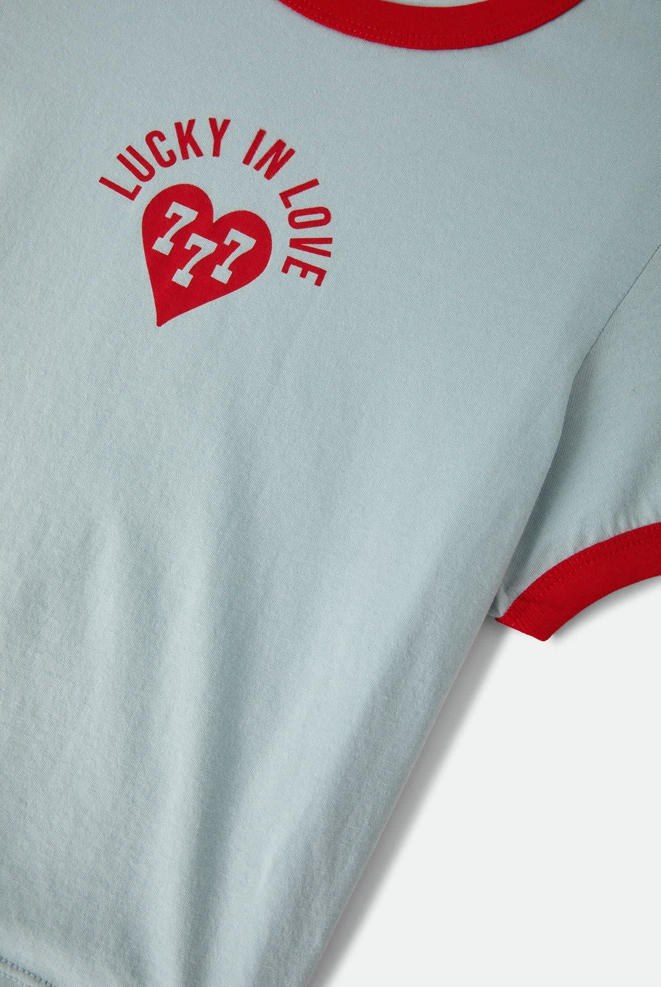 Women's Lucky In Love Baby T-Shirt in the color Sea Grass/Adrenaline Red - Additional Laydown image