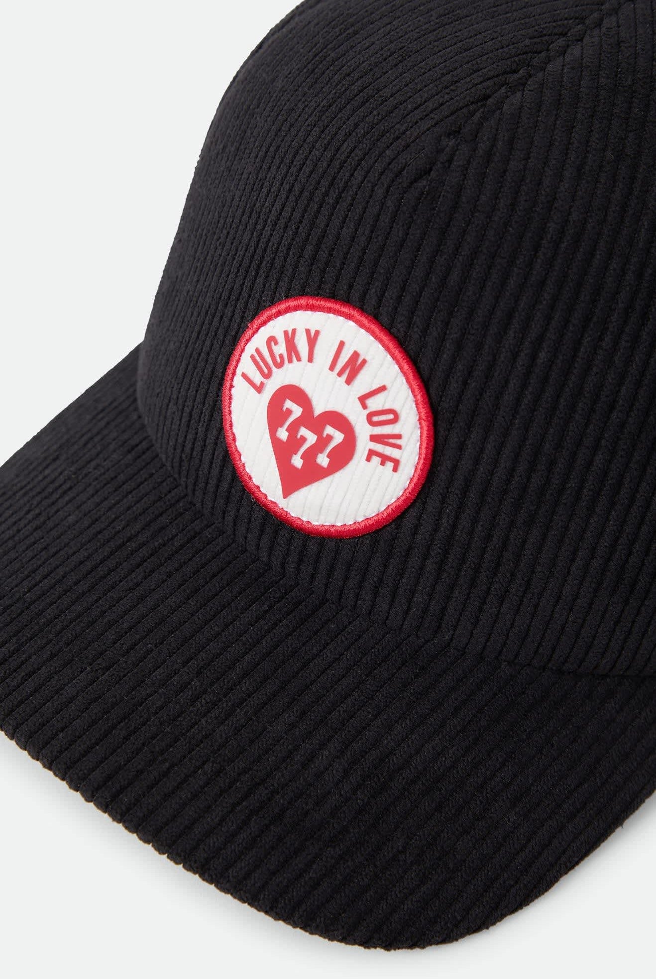 Unisex Lucky In Love Trucker Hat in the color Black - Additional Laydown image