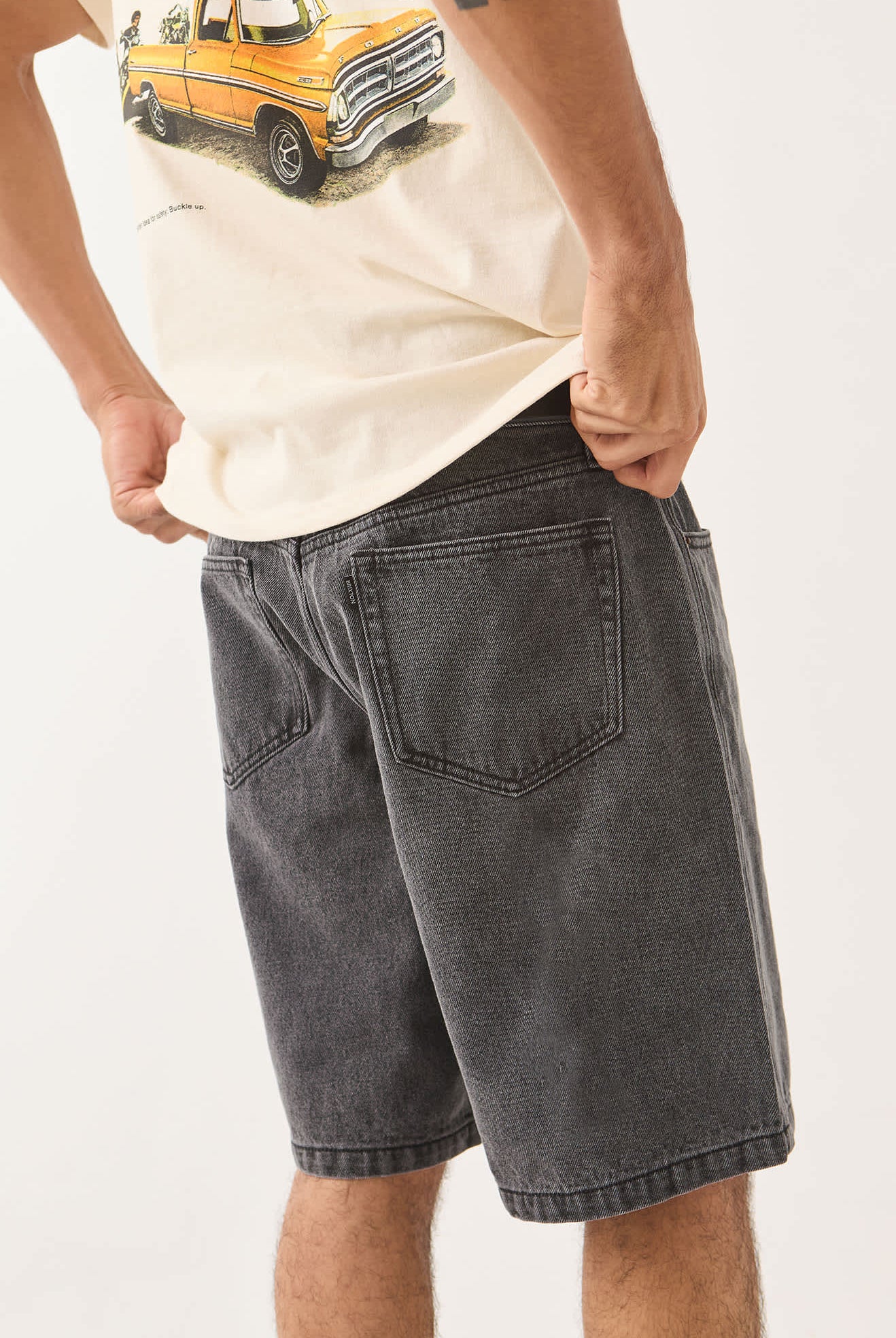 Men's Brixton Relaxed Short in the color Washed Black Denim - Men's Side View