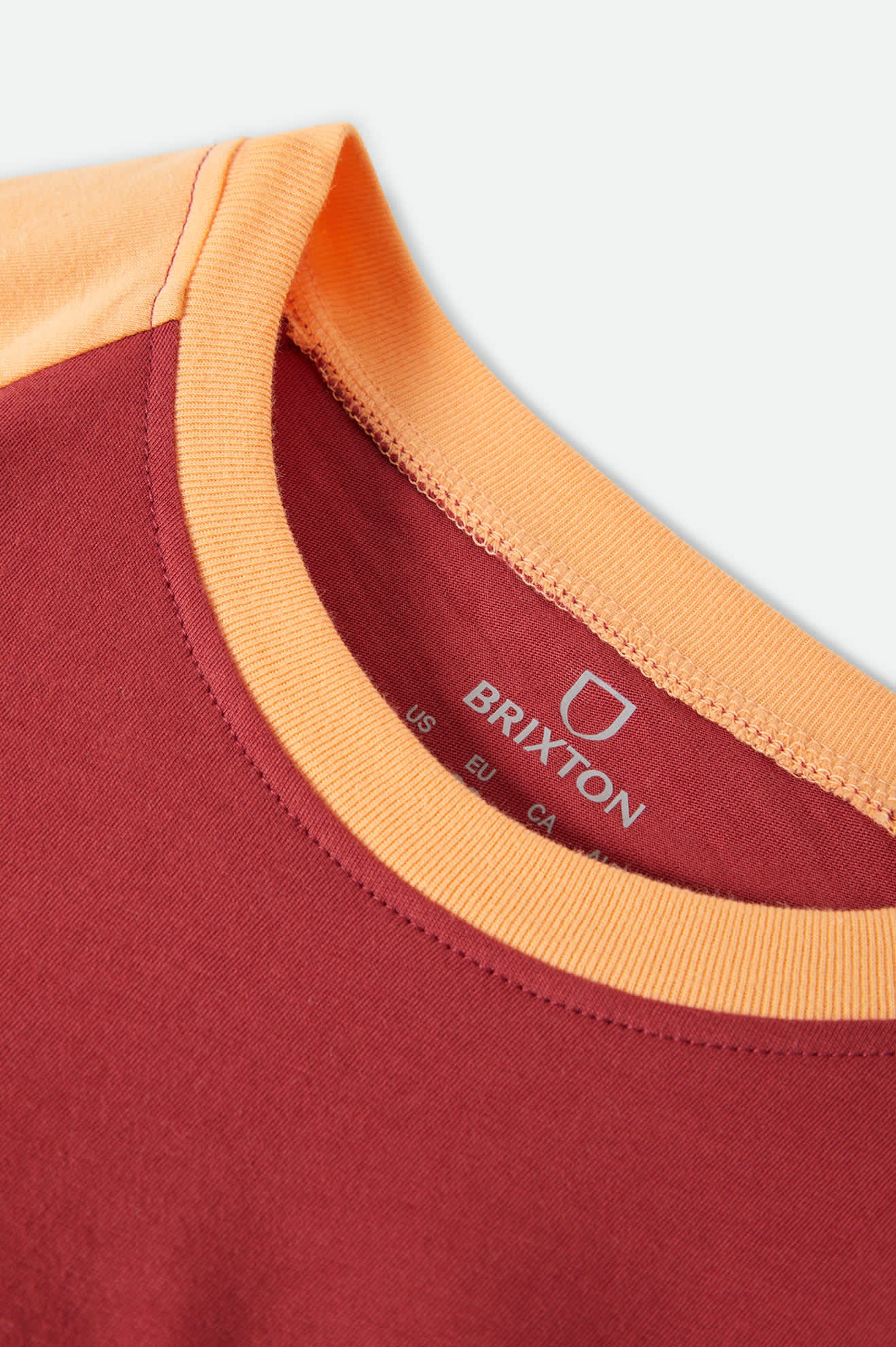 Women's Swallow Sky Cropped Raglan in the color Robust Red/Peach Cobbler - Additional Laydown image