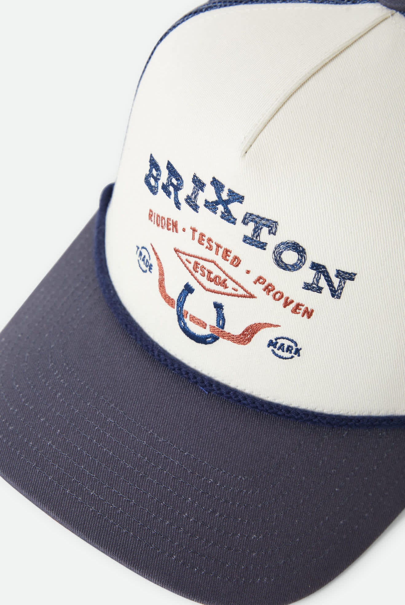 Unisex Beekman Netplus Trucker Hat in the color Off White/Navy - Additional Laydown image