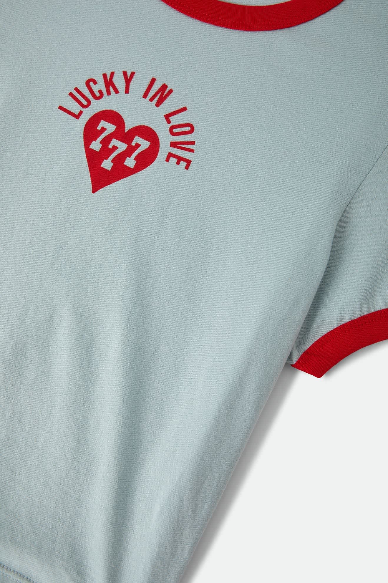 Women's Lucky In Love Baby T-Shirt in the color Sea Grass/Adrenaline Red - Additional Laydown image