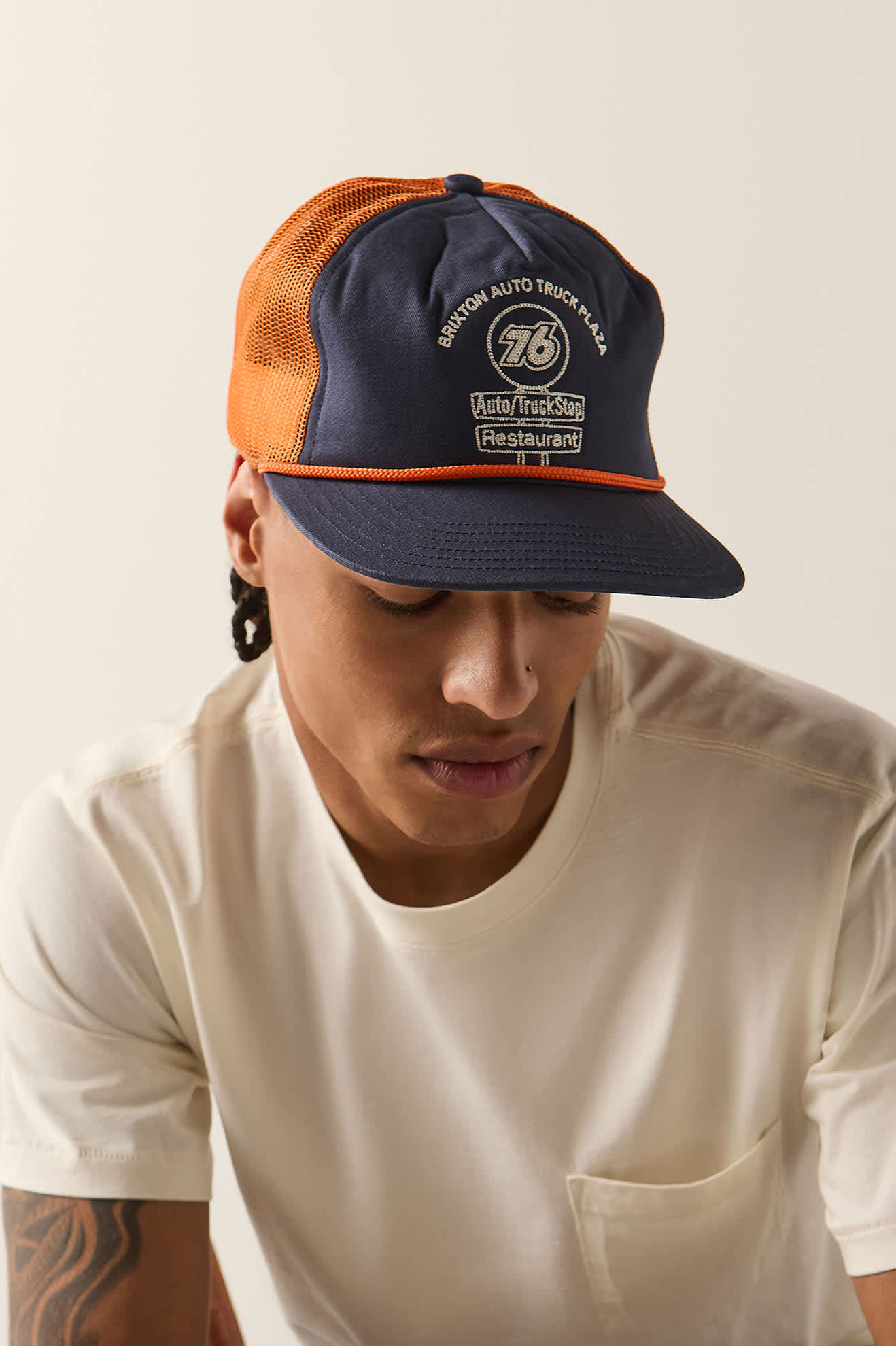 Unisex 76 Truck Stop Trucker Hat in the color Navy/Orange - Additional Fit image