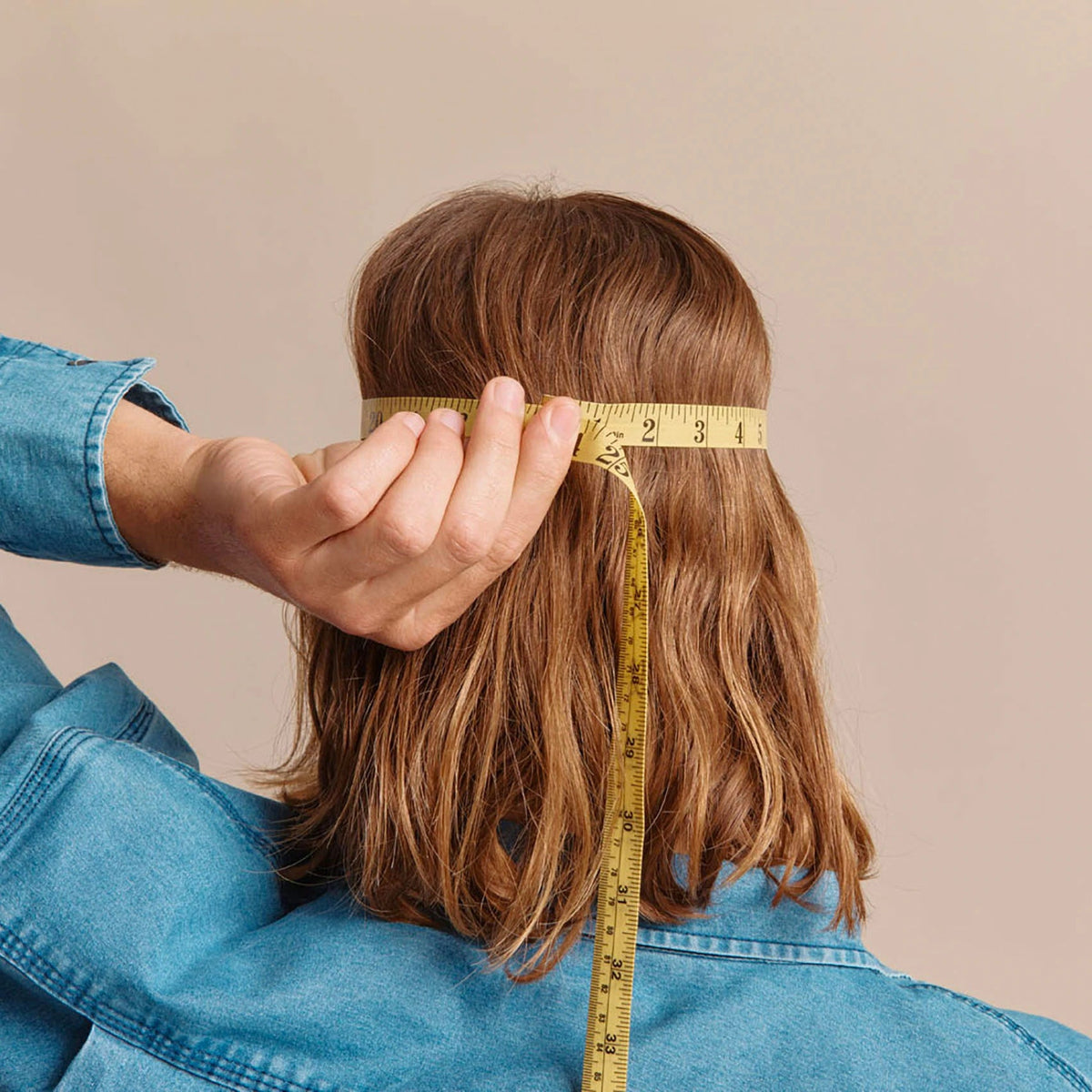 a person measuring their head