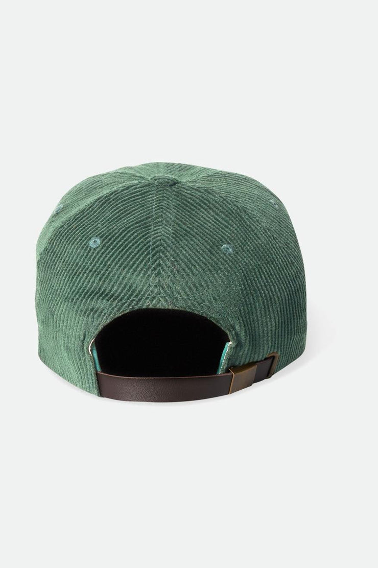 a green corduroy hat with a brown leather strap