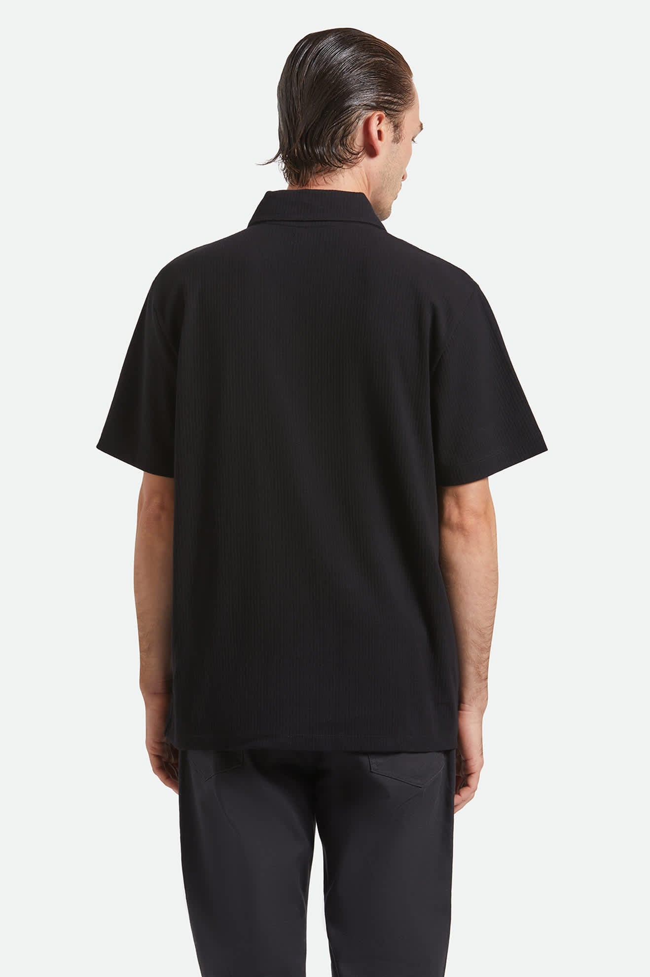 Men's Ribbed City S/S Polo in the color Black - Men's Back View